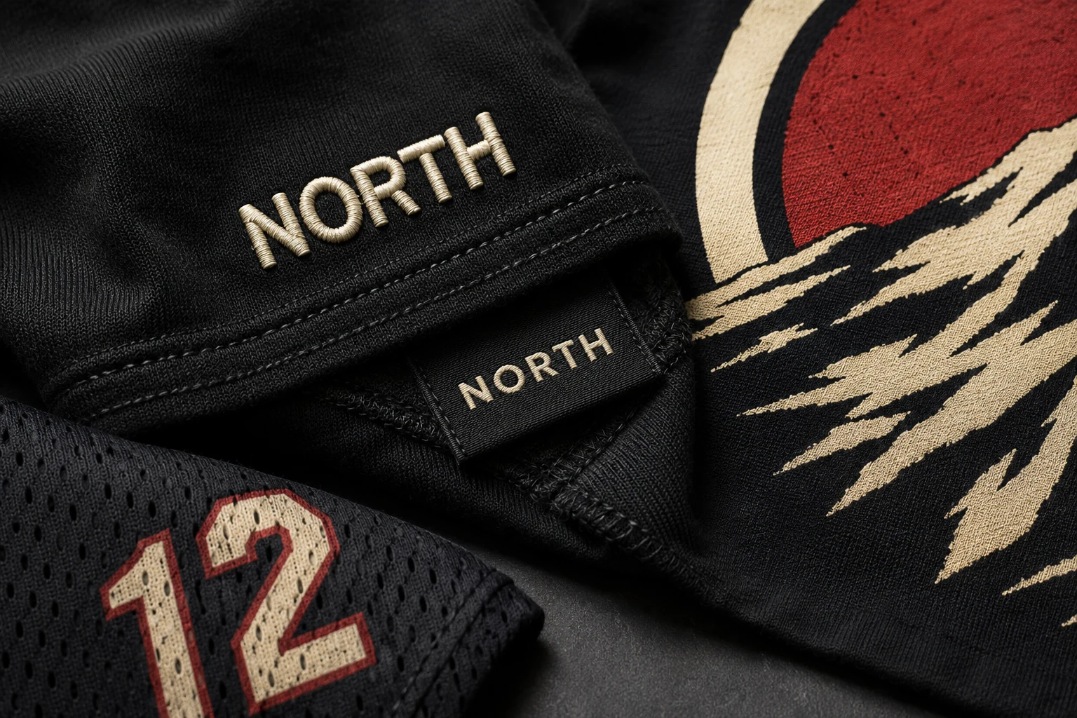 Close-up of embroidered lettering, a woven label, a print, and jersey graphics on custom textile pieces
